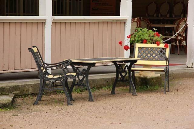 Two chairs and a table representing durable outdoor furniture.