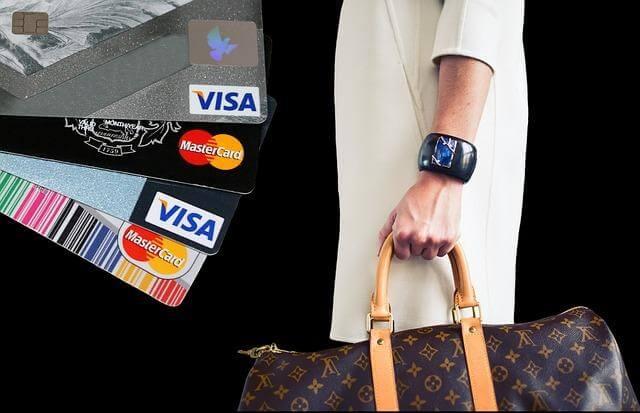 Woman holding credit cards and a purse