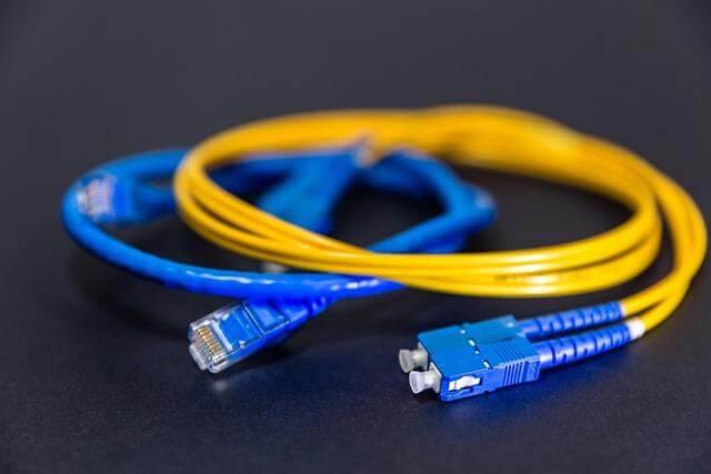 Yellow and blue internet cables on a black surface