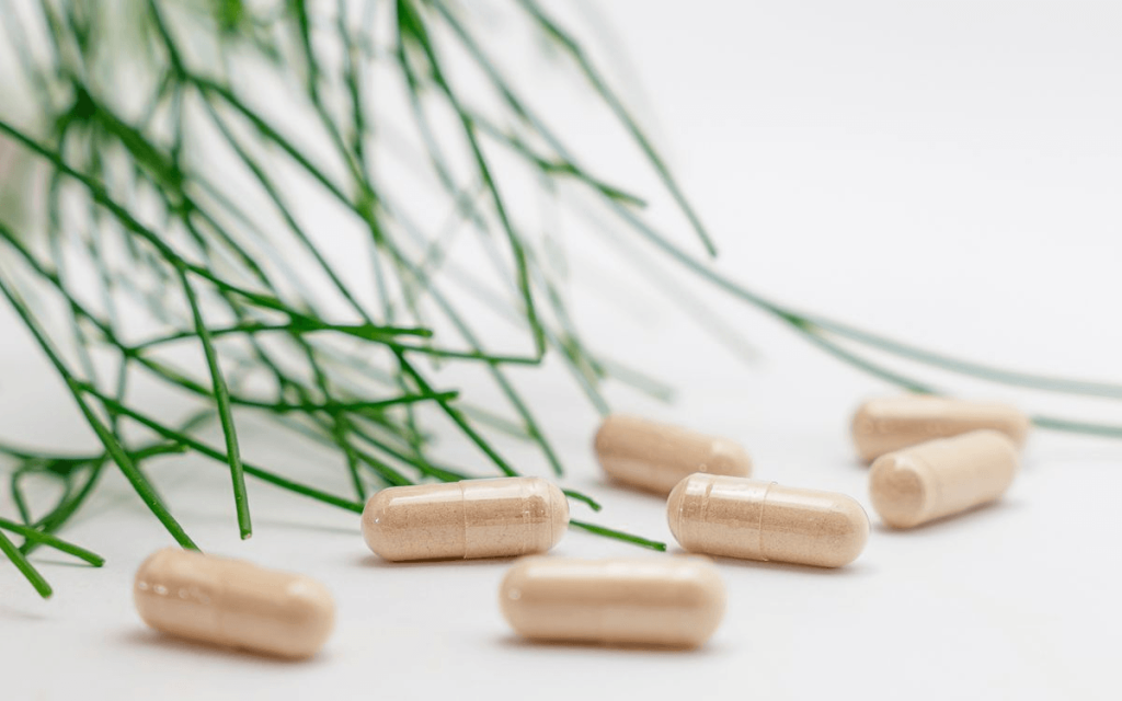 A bunch of supplement pills on a table
