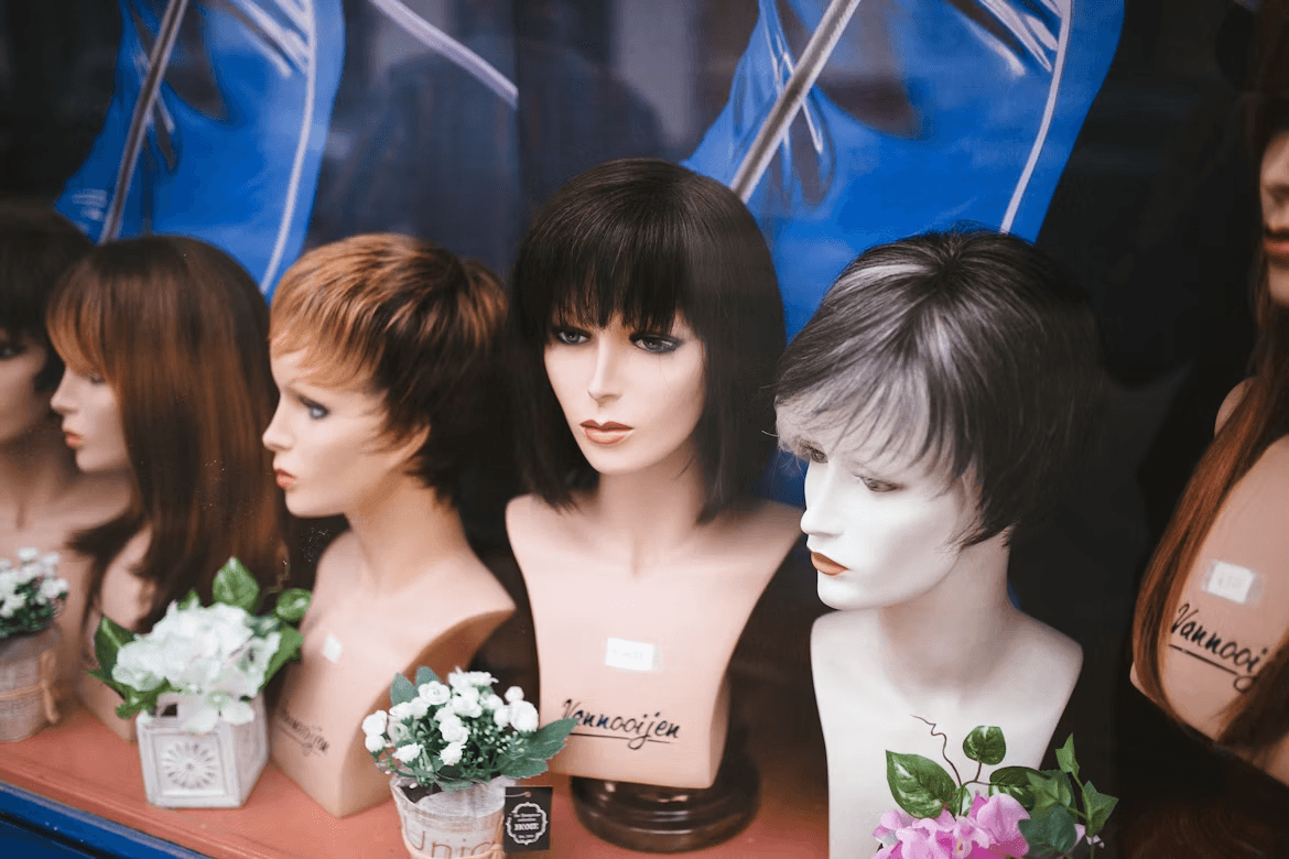 The Busy Woman’s Guide to Wigs: How to Get Perfect Hair in Under 5 Minutes Kelly Bejelly Mannequins displaying wigs in a store window