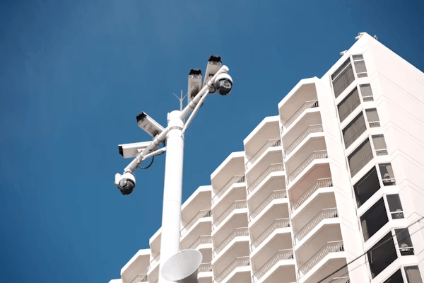 Tall white building next to a street