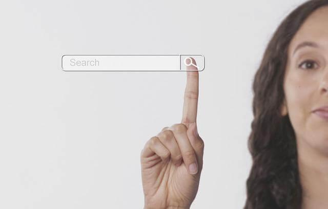 Woman pointing to a search button, representing modern