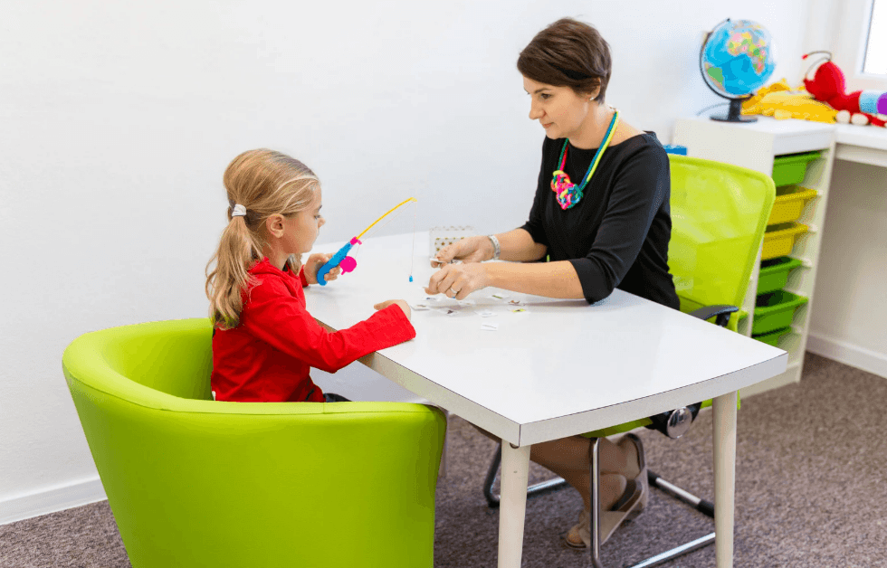 A woman and a young girl sitting at a