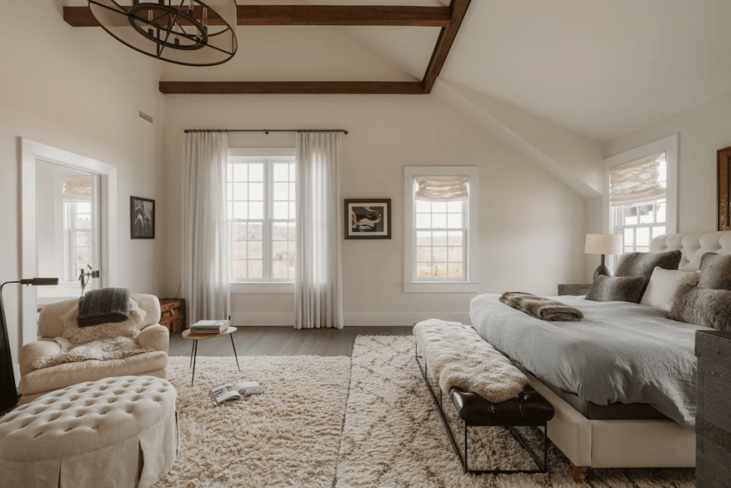 Elegant large bedroom with a king-size bed and a contemporary couch