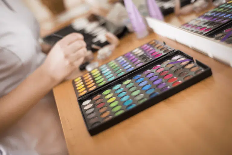 Person at table with colorful crayons