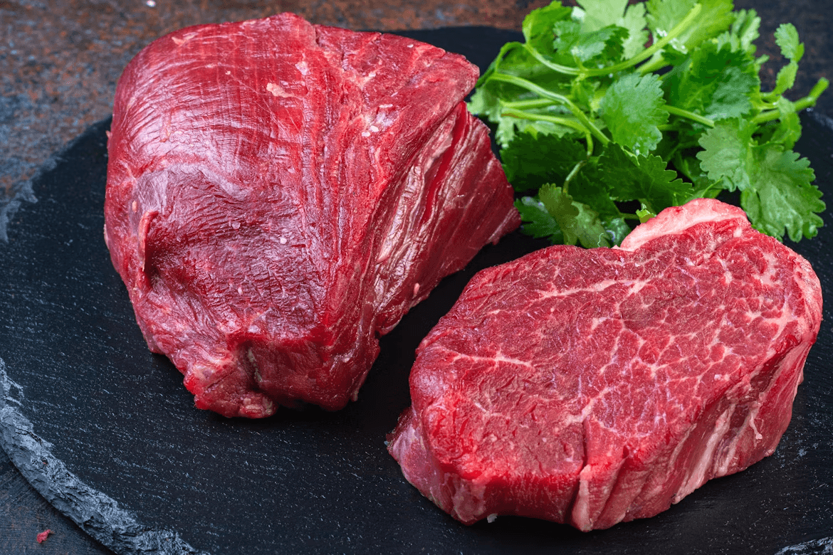 Two organic beef steaks on a plate with parsley
