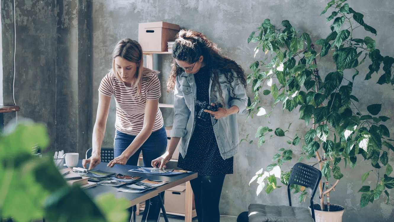 Two women looking at printable photo projects on a