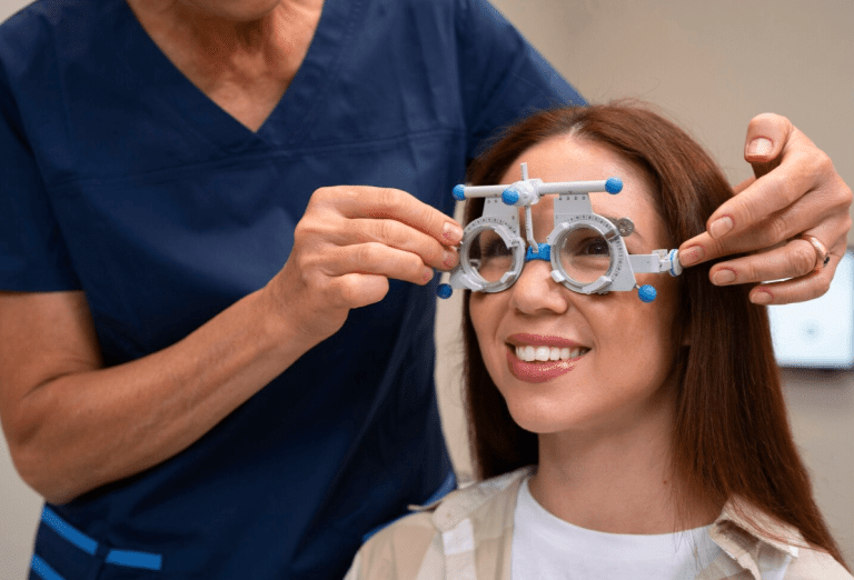 Woman getting glasses put on by an optometrist