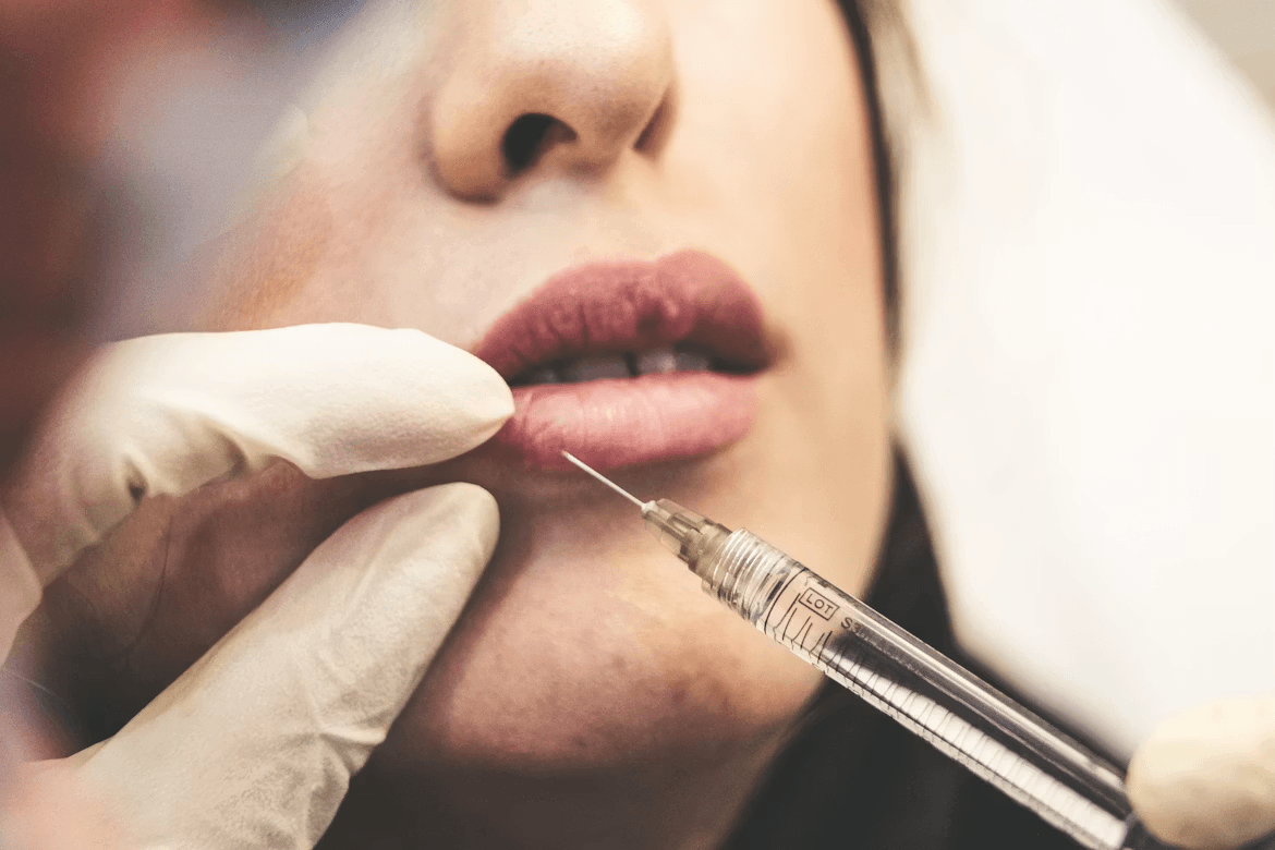 Woman getting lips examined by a doctor for injectable correction