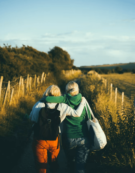 A couple walking on a dirt road, symbolizing