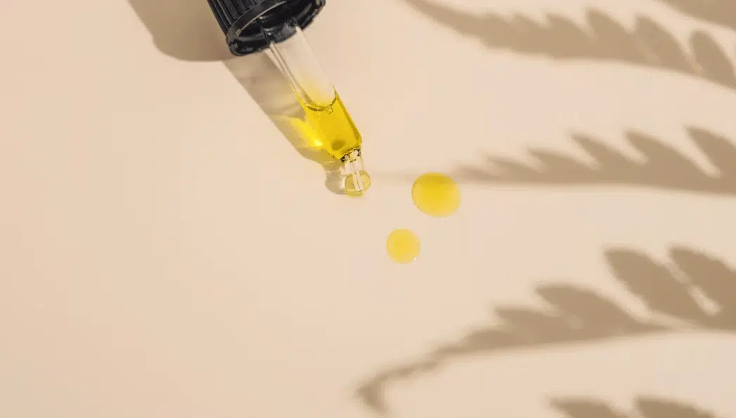 CBD oil dropper bottle next to a