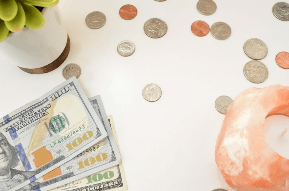 Donut and money on a table, symbolizing financial