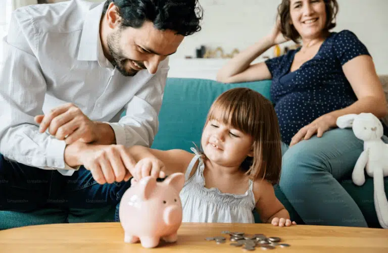 Man puts coins into a piggy bank, symbolizing