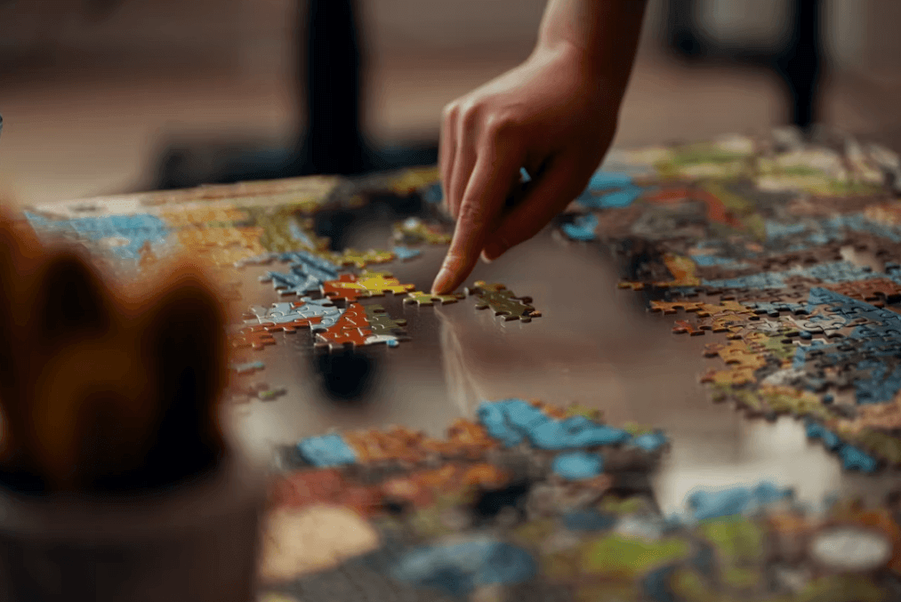 Person placing a puzzle piece, symbolizing picking up