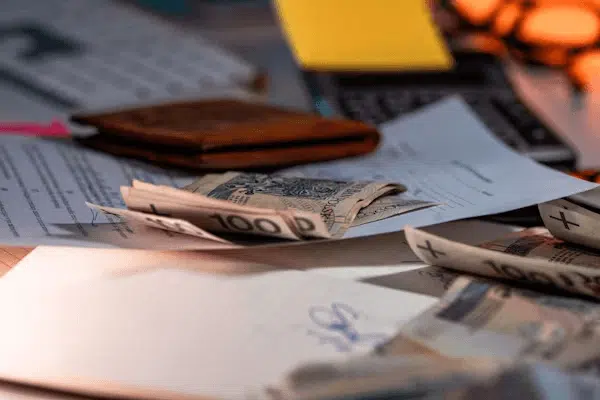 Pile of money on a table, representing