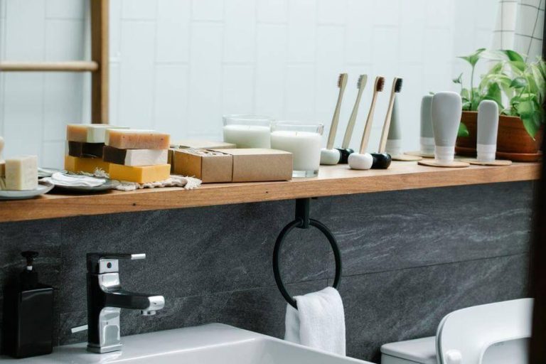 A bathroom counter with soap and toothbrushes