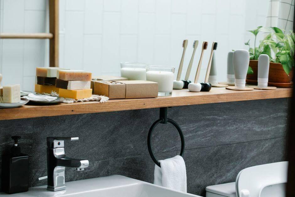 A bathroom counter with soap and toothbrushes