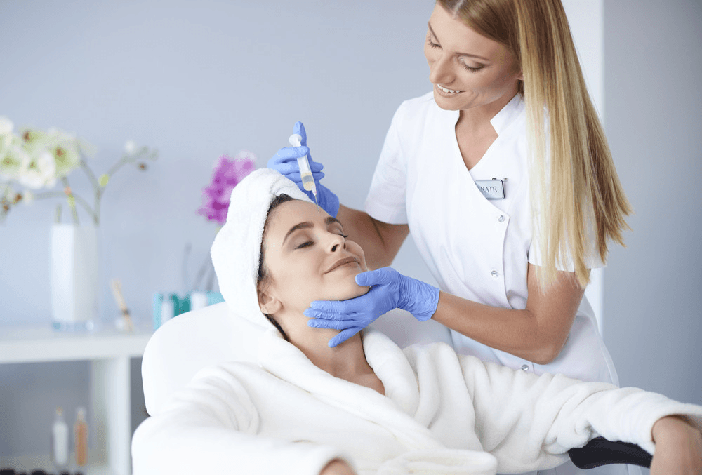 A woman getting her hair cut by a