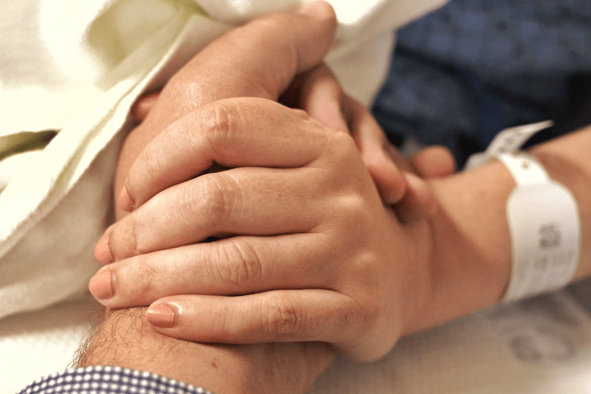 Close up of two hands held in support