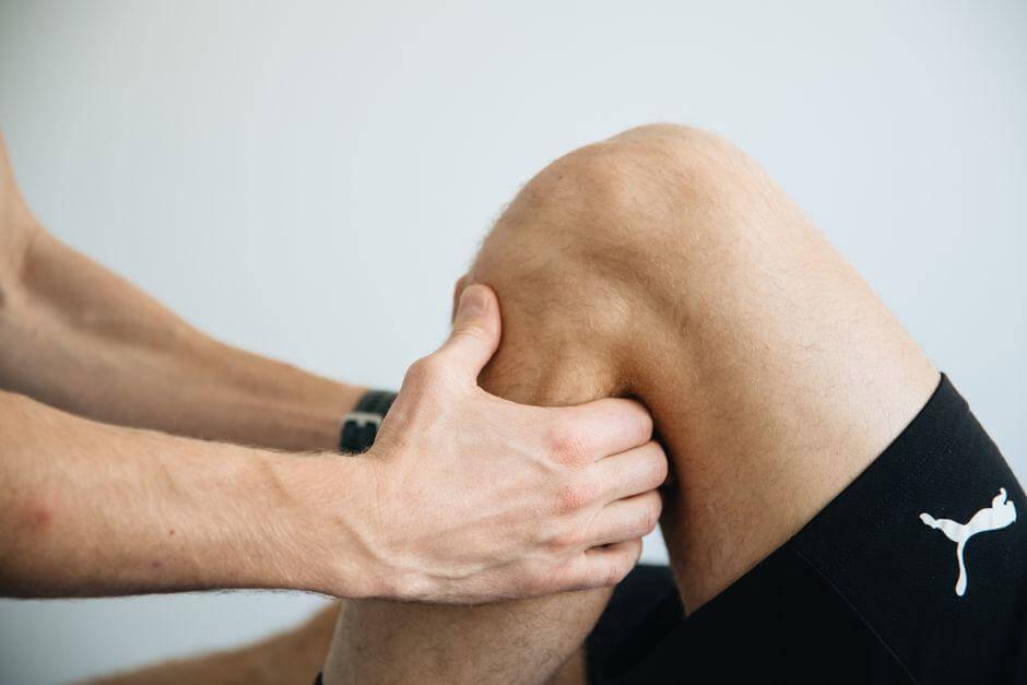 Man holding knee, considering PRP therapy