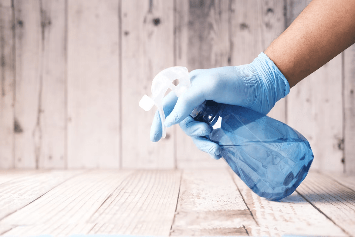 Person in blue gloves handling a pest control plastic