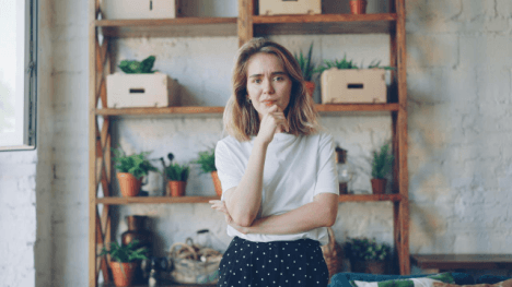 Woman standing in front of a plant shelf