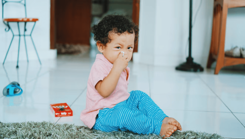 A small child eating on the floor