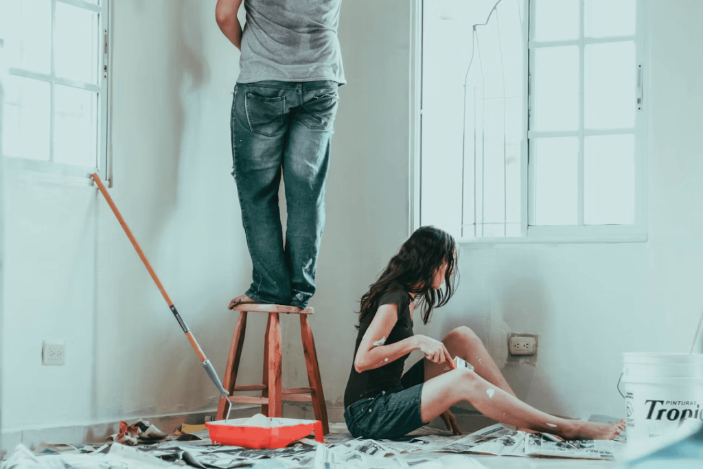 Couple on a ladder for home repair