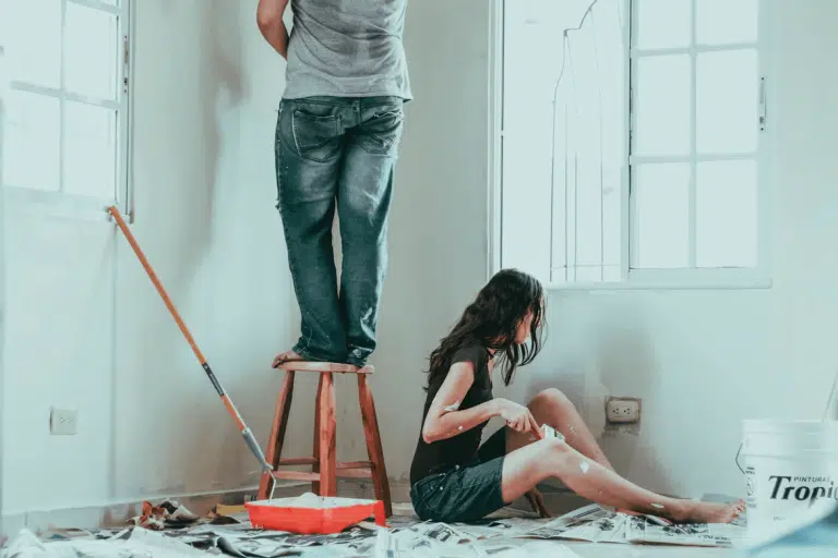 Couple on a ladder for home repair