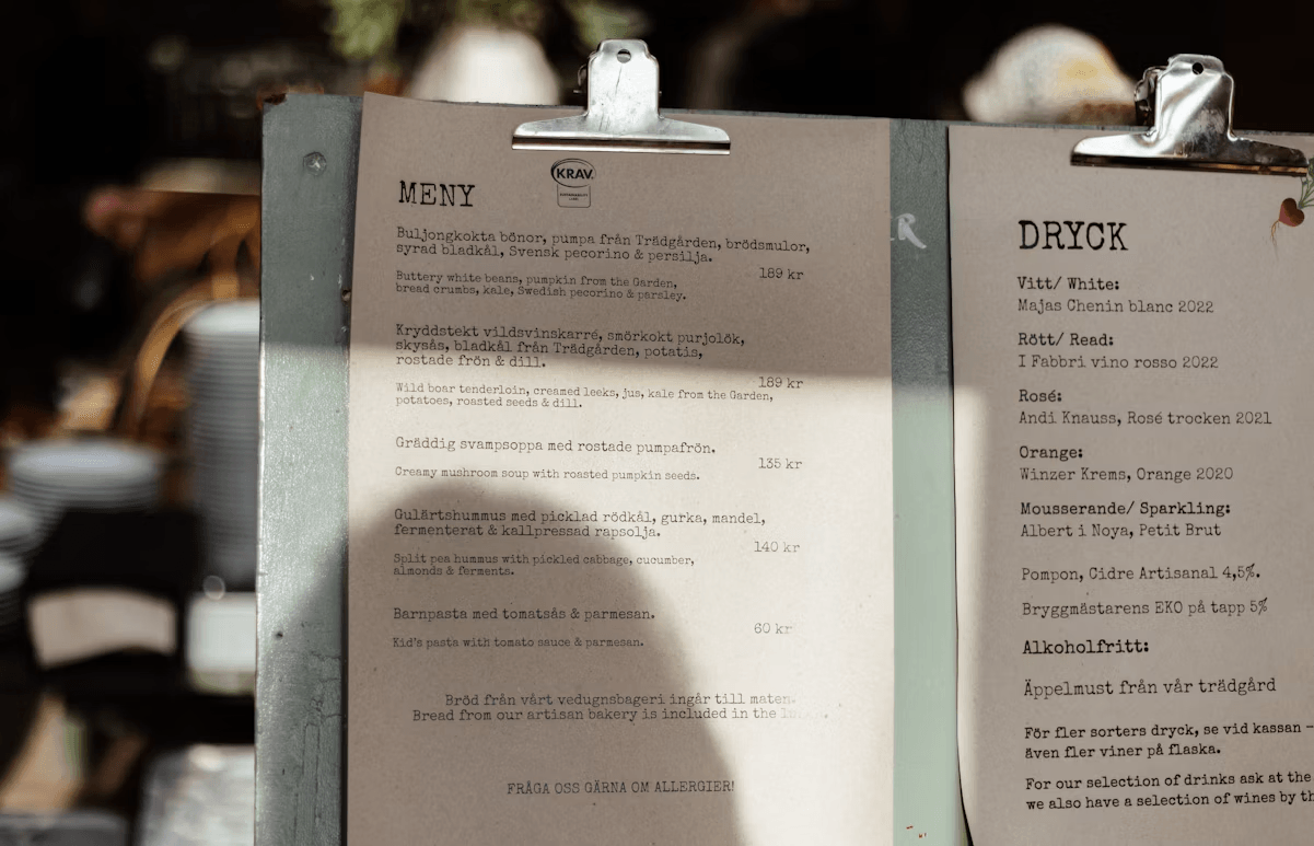 Two restaurant menus on a metal stand