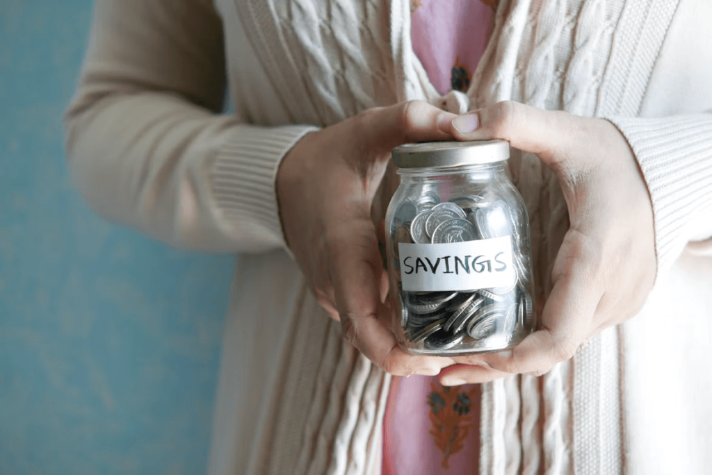 Woman holding a savings jar for winter preparation