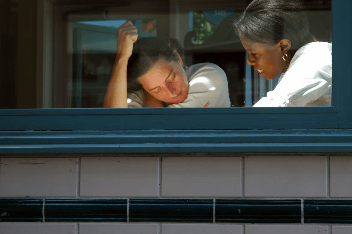 Woman looking out a window, observing