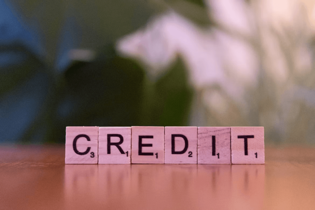 Wooden blocks spelling 'credit' on a table,
