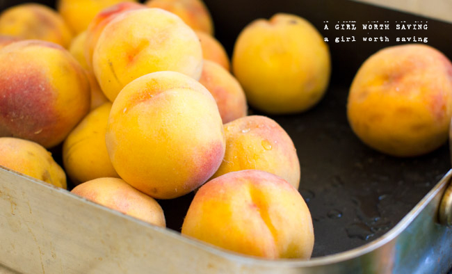Washed Peaches in a  large pan in this tutorial on How to Freeze Peaches