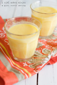 two peach smoothies in a glass
